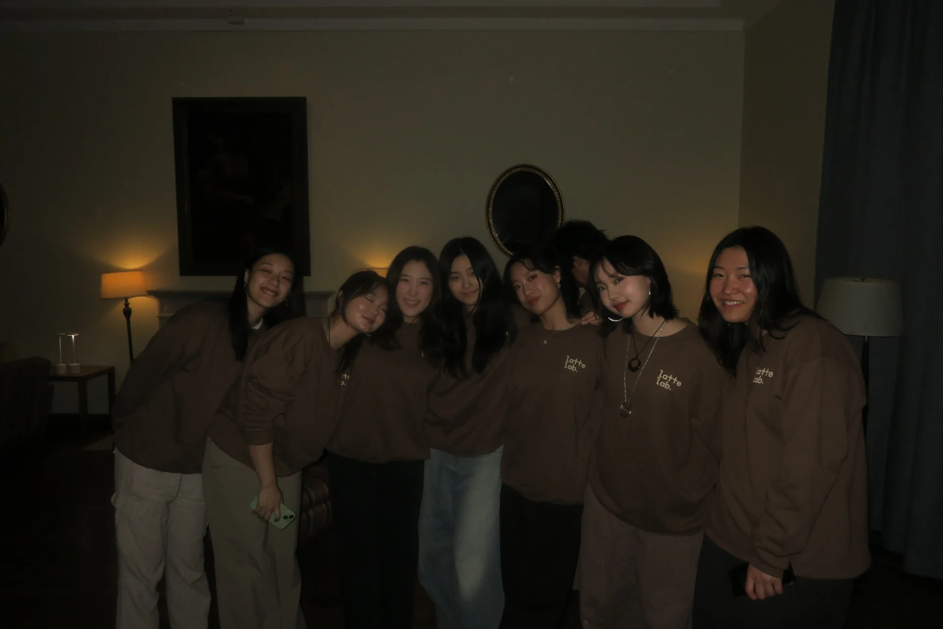 Latte Lab members posing together in matching brown Latte Lab sweatshirts
